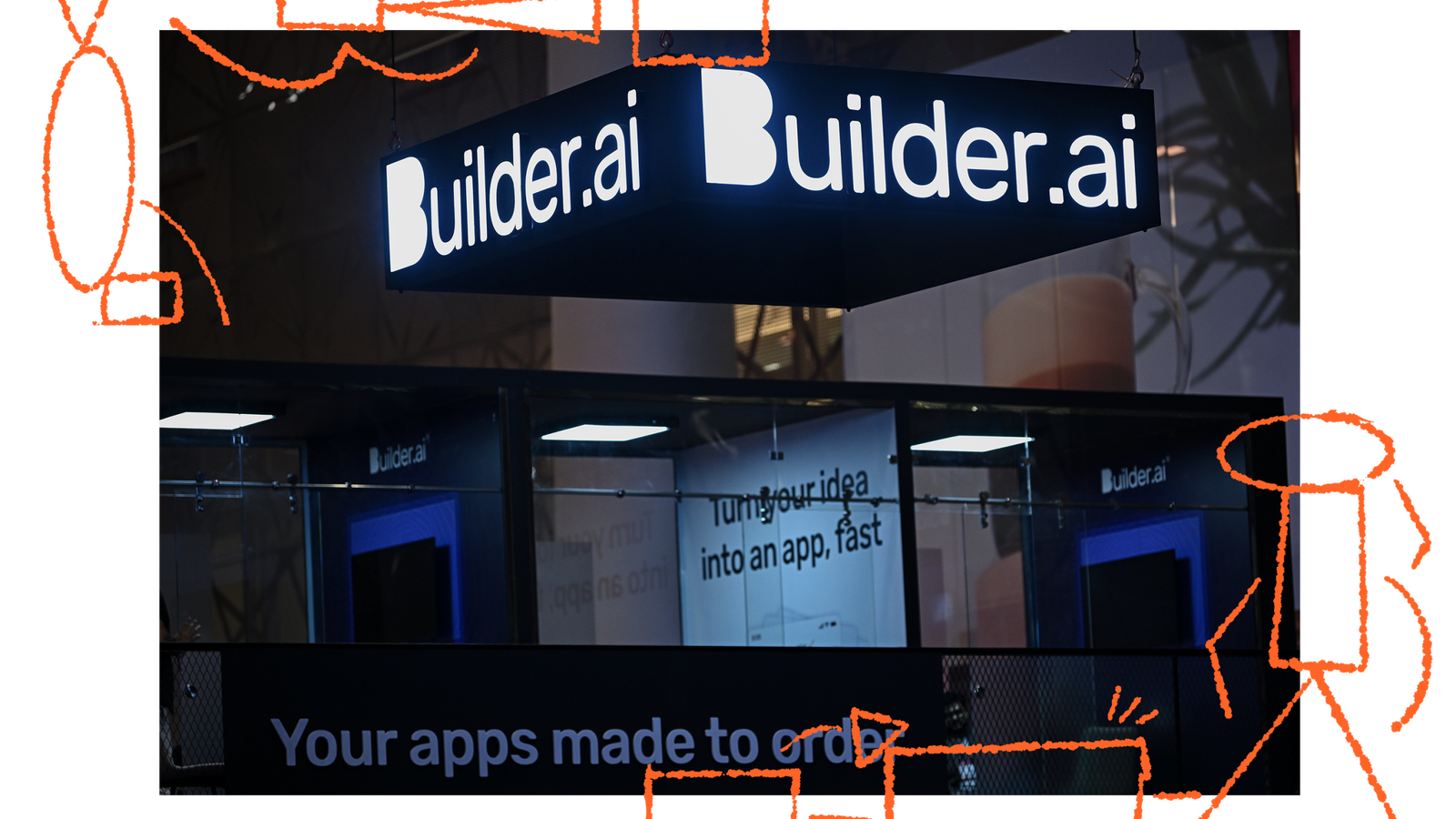 A marketing booth featuring a prominent illuminated sign that reads 'Builder.ai,' with additional text stating 'Your apps made to order' and 'Turning your idea into an app, fast.' The booth has a modern design with glass panels and overhead lighting.