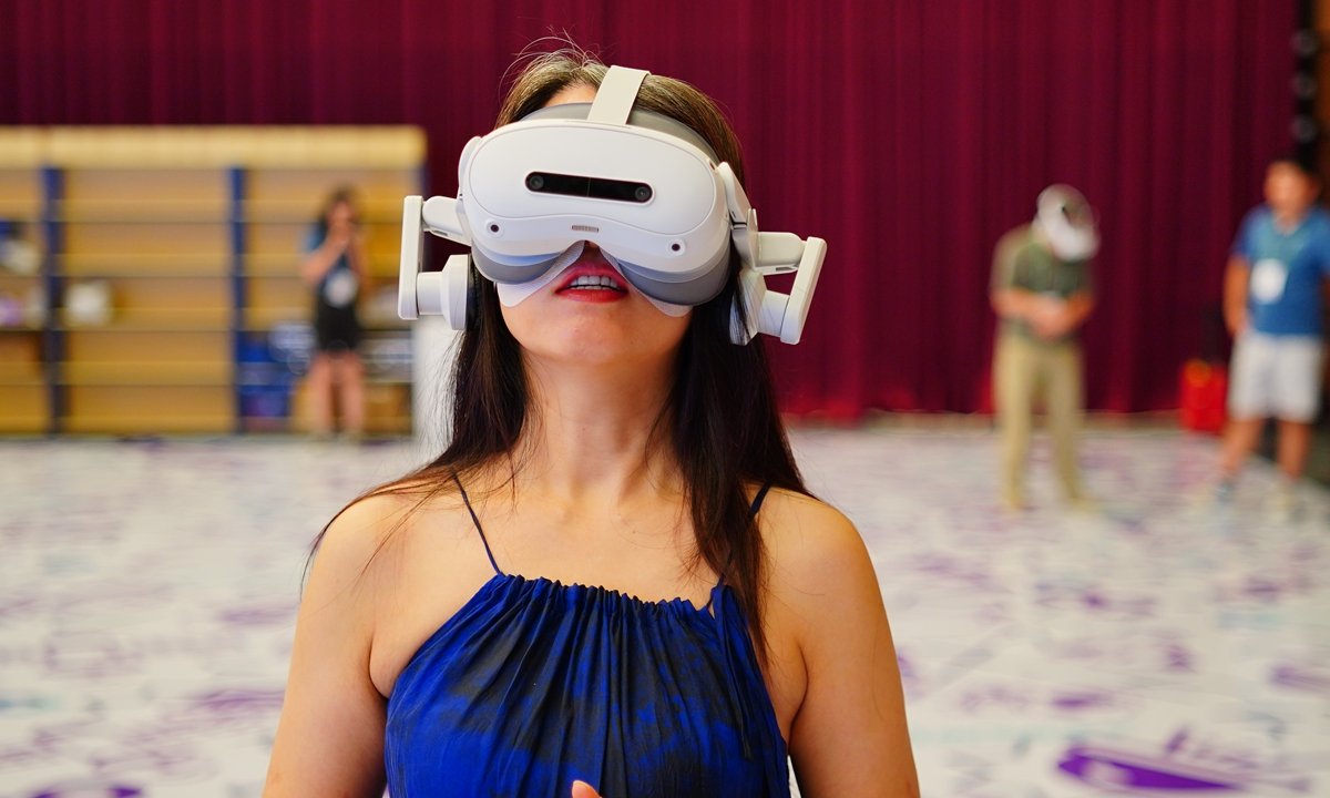 A participant tries out a wearable innovative device at the 24th China Internet Conference in Beijing on July 23, 2025. Photo: IC