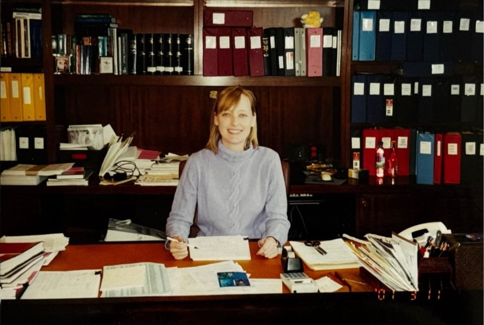 Julie Sweet sits behind a desk at Cravath, Swaine & Moore.