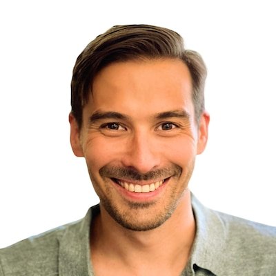 Headshot of a man with dark hair. He wears a sage shirt.