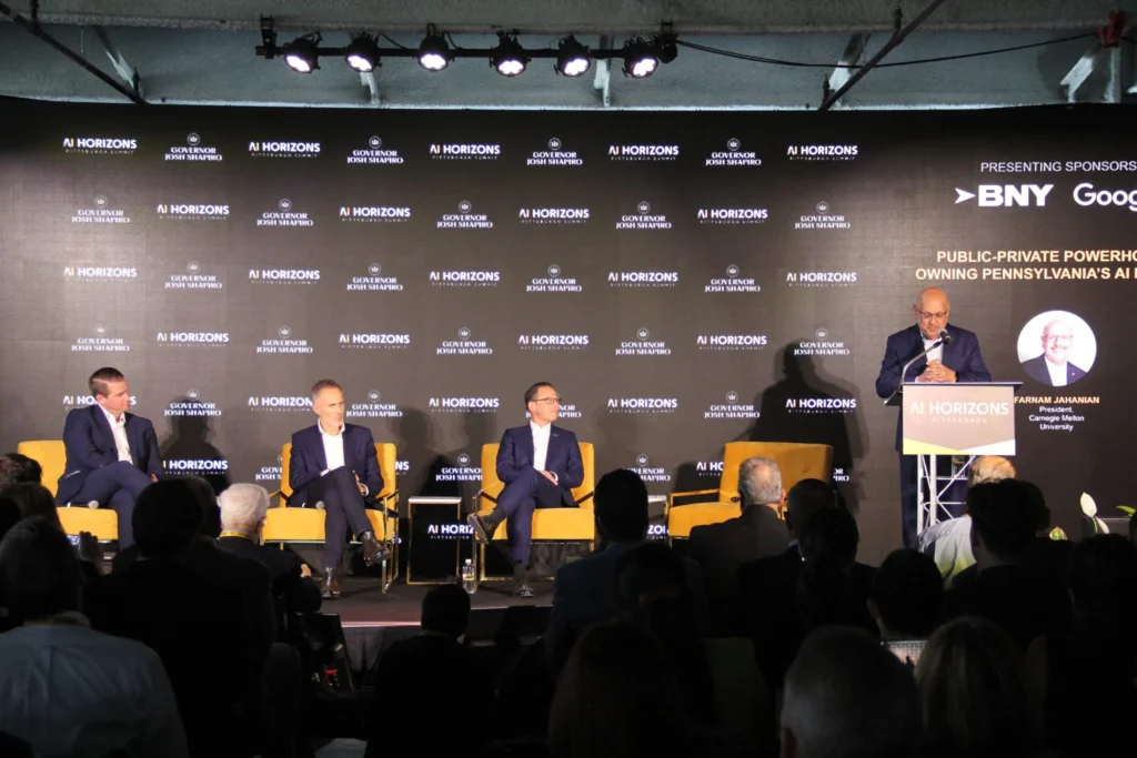 Carnegie Mellon University President Farnam Jahanian, right, speaks at the AI Horizons Summit alongside Gov. Josh Shapiro, center, and other panelists. (Photo by Eric Jankiewicz/Pittsburgh’s Public Source)
